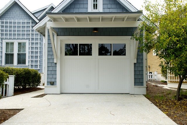 bílá garážová vrata u domku